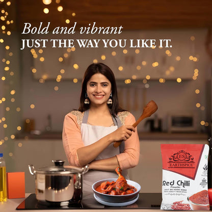Woman in a kitchen with Earthspice red chili powder.