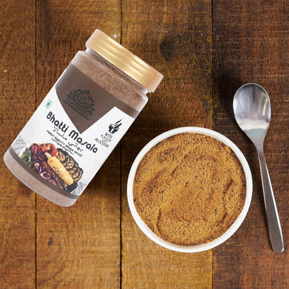 Earthspice Bhatti Masala and bowl on a wooden surface.