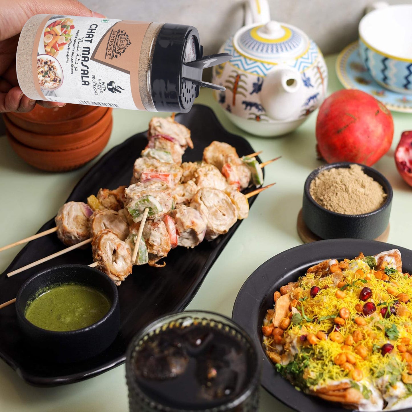Skewered food with Earthspice Chaat Masala, surrounded by various dishes