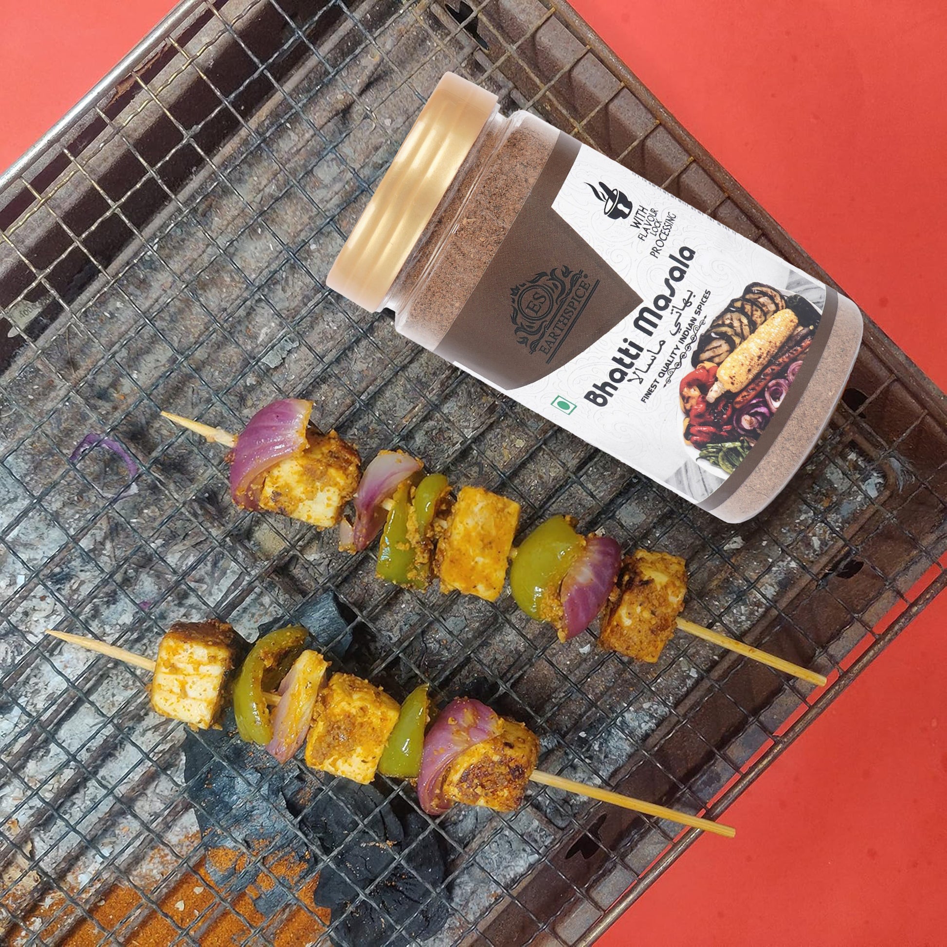 Earthspice Bhatti Masala on a grill with skewered vegetables.