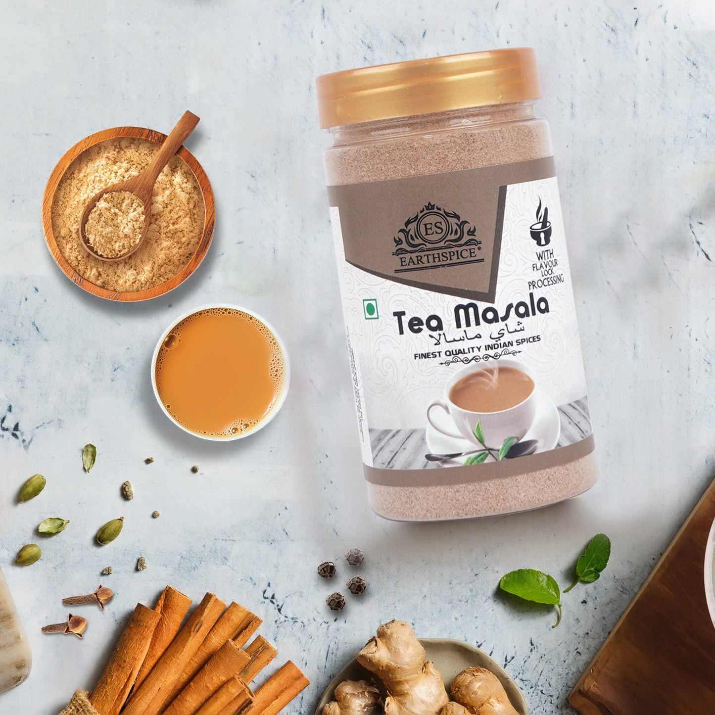 Earthspice Tea Masala with a cup of tea and tea leaves.