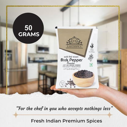 Hand holding a package of Earthspice black pepper powder.